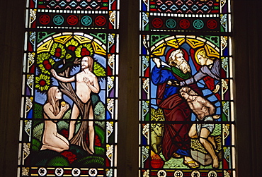 Stained glass of Adam and Eve, and Abraham preparing to sacrifice Isaac, St. Mary's church, Deerhurst, Gloucestershire, England, United Kingdom, Europe