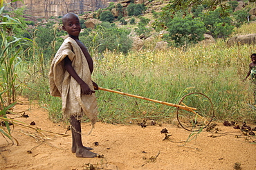 Dogon boy with home made toy, Mali, Africa