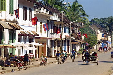 Flags hang outside houses along street, Luang Prabang, Laos, Indochina, Southeast Asia, Asia