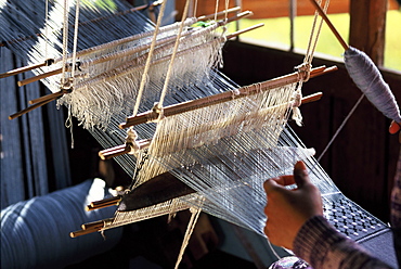 Weaving cotton fabrics on a traditional multiple-harness frame loom, Inle Lake, Shan State, Myanmar (Burma), Asia