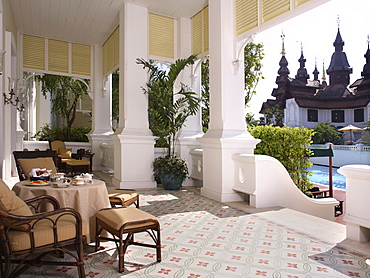 Outdoor dining on the balcony with a pool view at the Mandarin Oriental Dhara Dhevi in Chiang Mai, Thailand, Southeast Asia, Asia