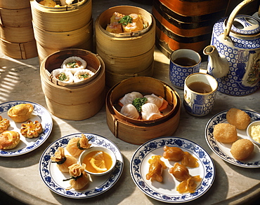 Steamers and plates of dim sum with tea, China, Asia