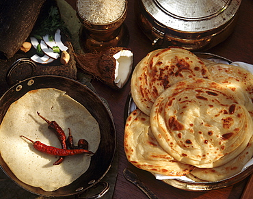 Appam, rice crepes on left, and paratha, India, Asia