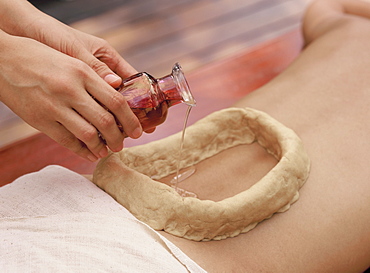 Kathi Vasti, an Ayurvedic treatment consisting of pouring medicated oil on various parts of the body and keeping it in place with a cup made of  dough