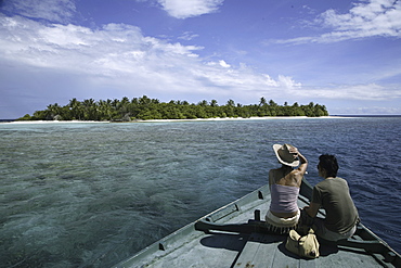 Couple arriving at an island, Maldives, Indian Ocean, Asia