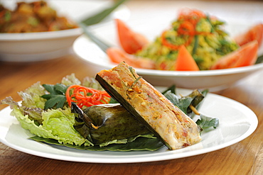 Balinese food, including Ikan pepes, fish grilled in a banana leaf packet, Bali, Indonesia, Southeast Asia, Asia