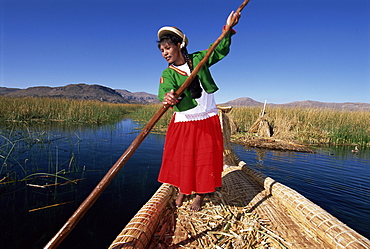 Portrait of a Uros Indian woman on a traditional reed boat, Islas Flotantes, floating islands, Lake Titicaca, Peru, South America