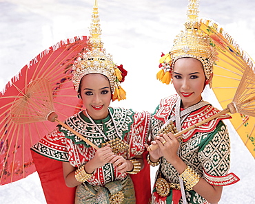 Portrait of two dancers in traditional Thai classical dance costume, smiling and looking at the camera, Bangkok, Thailand, Southeast Asia, Asia