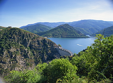 The Cevennes Dam, with the Lac de Villefort and hills in the background, in Lozere, Languedoc Roussillon, France, Europe