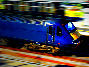 A blue locomotive travelling at speed