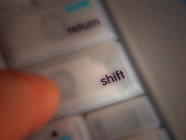 Pressing the Shift key on a computer keyboard