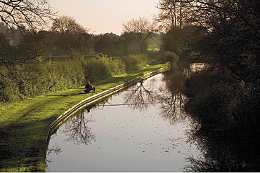 Man fishing from the towpath, Worcester and Birmingham canal, Hanbury, Worcestershire, Midlands, England, United Kingdom, Europe