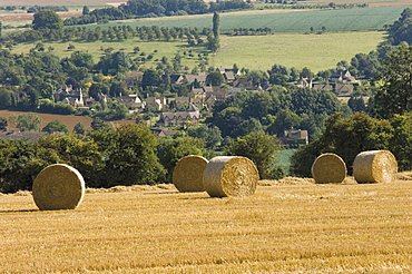 Bales of hay with Chipping Campden beyond, from the Cotswolds Way footpath, The Cotswolds, Gloucestershire, England, United Kingdom, Europe