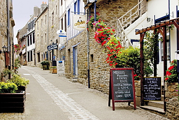 Narrow street with half timbered houses and seafood restaurants, Treguier, Cote de Granit Rose, Cotes d'Armor, Brittany, France, Europe