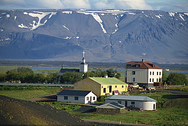 Village and church south of Lake Myvatn with hills in the background, at Skutustadir, Iceland, Polar Regions