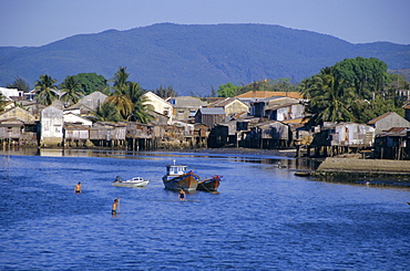 Fishermen's houses, boats and weed gatherers, Nha Trang, Vietnam, Indochina, Southeast Asia, Asia