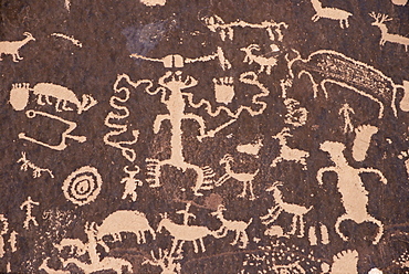 Indian petroglyphs drawn on red standstone by scratching away dark desert varnish of iron oxides, Newspaper Rock, Canyonlands, Utah, United States of America, North America