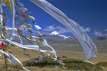 Prayer flags on top of low pass on Barga Plain, with Mount Kailas (Kailash) beyond, sacred mountain for Buddhists and Hindus, Tibet, China, Asia