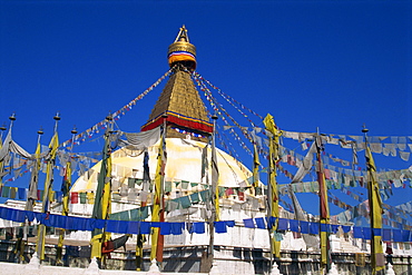 Prayer flags around the dome of one of the world's largest Buddhist stupas at Boudhanath, UNESCO World Heritage Site, Kathmandu, Nepal, Asia