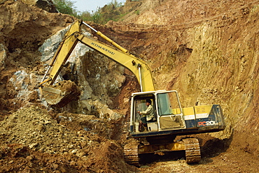 Machine digging gem-bearing clay in large open pit mine, Mogok ruby mines, Mandalay District, Myanmar (Burma), Asia