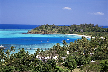 Lagoon with coral sand beach protected by outer coral reef, Mana Island in Mamanuca Group, Fiji