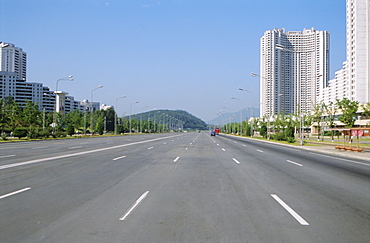 Blocks of flats beside road to Nampo, ten lanes wide but no traffic, Pyongyang, North Korea, Asia