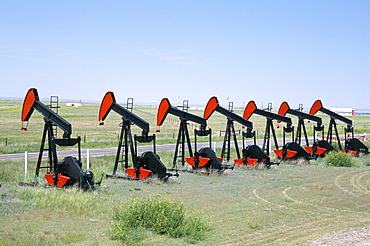 Oil pumps (nodding donkeys) for sale at oilfield supply merchants, Shelby, Montana, United States of America, North America