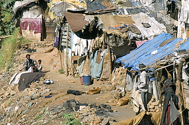 Untouchables (Harijan) in shanty hovels alongside river in town centre, Coonor, Tamil Nadu, India, Asia