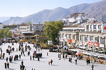 Main square in front of Jokhang, Potala palace beyond, Lhasa, Tibet, China, Asia