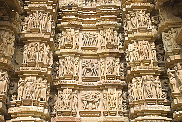 Some of the 646 erotic figures carved in sandstone on exterior of the Kandariya Mahadeva Temple, largest of the Chandela temples, within Western Group, Khajuraho, UNESCO World Heritage Site, Madhya Pradesh state, India, Asia