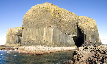 Columnar basalt lava with Fingal's Cave cut into it by sea, Staffa, off west coast of Mull, Inner Hebrides, Scotland, United Kingdom, Europe