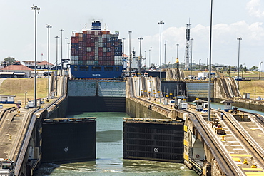 Panamax-sized container ship goiing up through Gatun Locks on Panama Canal, Panama, Central America