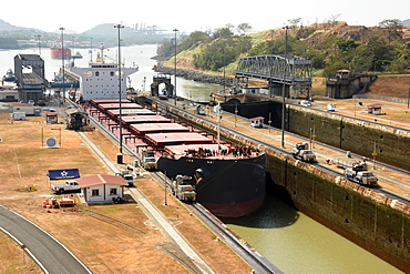 Electric mules guiding Panamax ship through Miraflores Locks on the Panama Canal, Panama, Central America