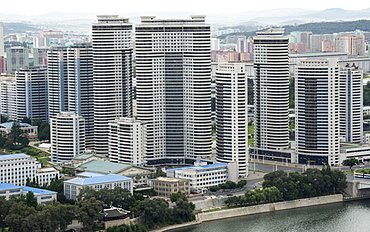 City centre tower blocks of flats, seen across Taedong River from Juche Tower, Pyongyang, North Korea, Asia