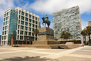 Montevideo, Uruguay; statue of Jose Artigas above his mausoleum, Parliament building on left