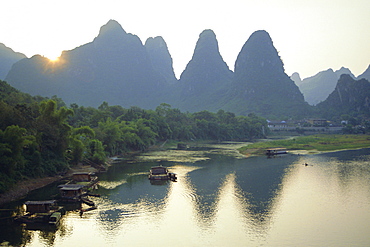 In Guilin limestone tower hills rise steeply above the Li River, Yangshuo, Guangxi Province, China