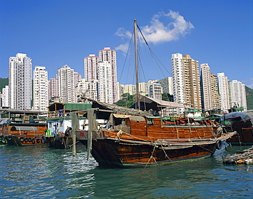 Boats in the harbour and high rise apartment buildings in the background at Aberdeen, Hong Kong, China, Asia