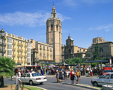 Busy street scene on the Plaza de Zaragoza with the cathedral beyond in the city of Valencia, Spain, Europe