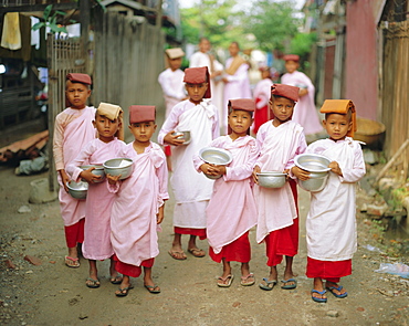 Young nuns with begging bowls, Mandalay, Myanmar, Asia