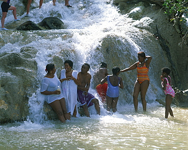 Local children under the Dunns River Falls, Jamaica, West Indies, Caribbean, Central America