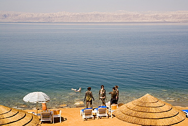 Dead Sea, from Movenpick hotel, showing people in healing mud, Israel in distance, from Jordan, Middle East