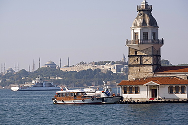 Maiden's tower (Kizkulesi), former tollbooth in Bosphorus, with Topkapi palace and minarets of Hagia Sophia and Blue Mosque in distance, Istanbul, Turkey, Europe