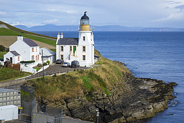 Holborn Head Lighthouse, Scrabster and view of distant Orkney Isles, Caithness, Scotland, United Kingdom, Europe