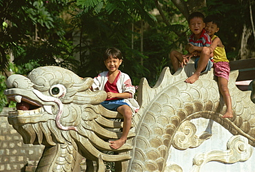 Children sitting on dragon, Long Son Pagoda, Nha Trang, Vietnam, Indochina, Southeast Asia, Asia