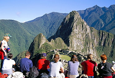 Tourists looking out over Machu Picchu, UNESCO World Heritage Site, Peru, South America