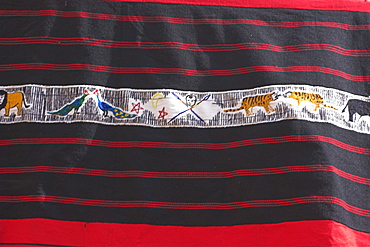 Traditional Naga blanket know as a body cloth with panel of painted animals, Lahe village, Sagaing Division, Myanmar (Burma), Asia