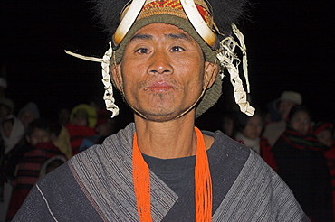 Naga man dancing at Grand Finale wearing headdress of woven cane decorated with wildboars teeth and bear fur, Naga New Year Festival, Lahe village, Sagaing Division,  Myanmar (Burma), Asia