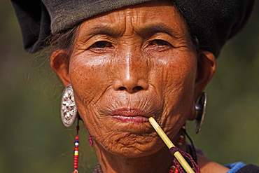 Wan Sai village (Aku tribe), Aku lady smoking wooden pipe, Kengtung (Kyaing Tong), Shan State, Myanmar (Burma), Asia