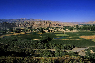 View of Bamiyan showing cliffs with two empty niches where the famous carved Buddhas stood, since destroyed by the Taliban, UNESCO World Heritage Site, Afghanistan, Asia