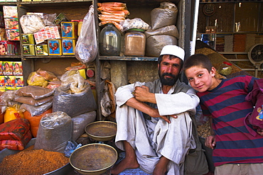 Shop keeper and boy in spice shop, bazaar, central Kabul, Afghanistan, Asia